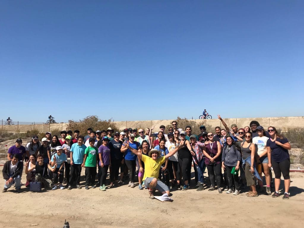 people posing for a photo with bikers in the background